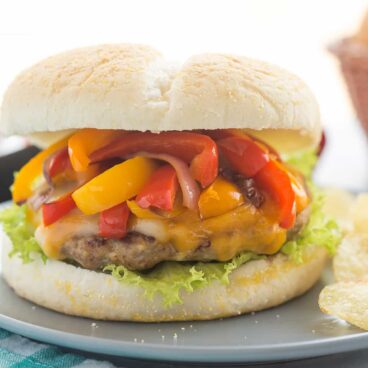 These Fajita Turkey Burgers are seasoned with Mexican spices and loaded with peppers, onions and cheese -- they're Chicken Fajitas in sandwich form! A fun, healthy twist on a burger! thereciperebel.com