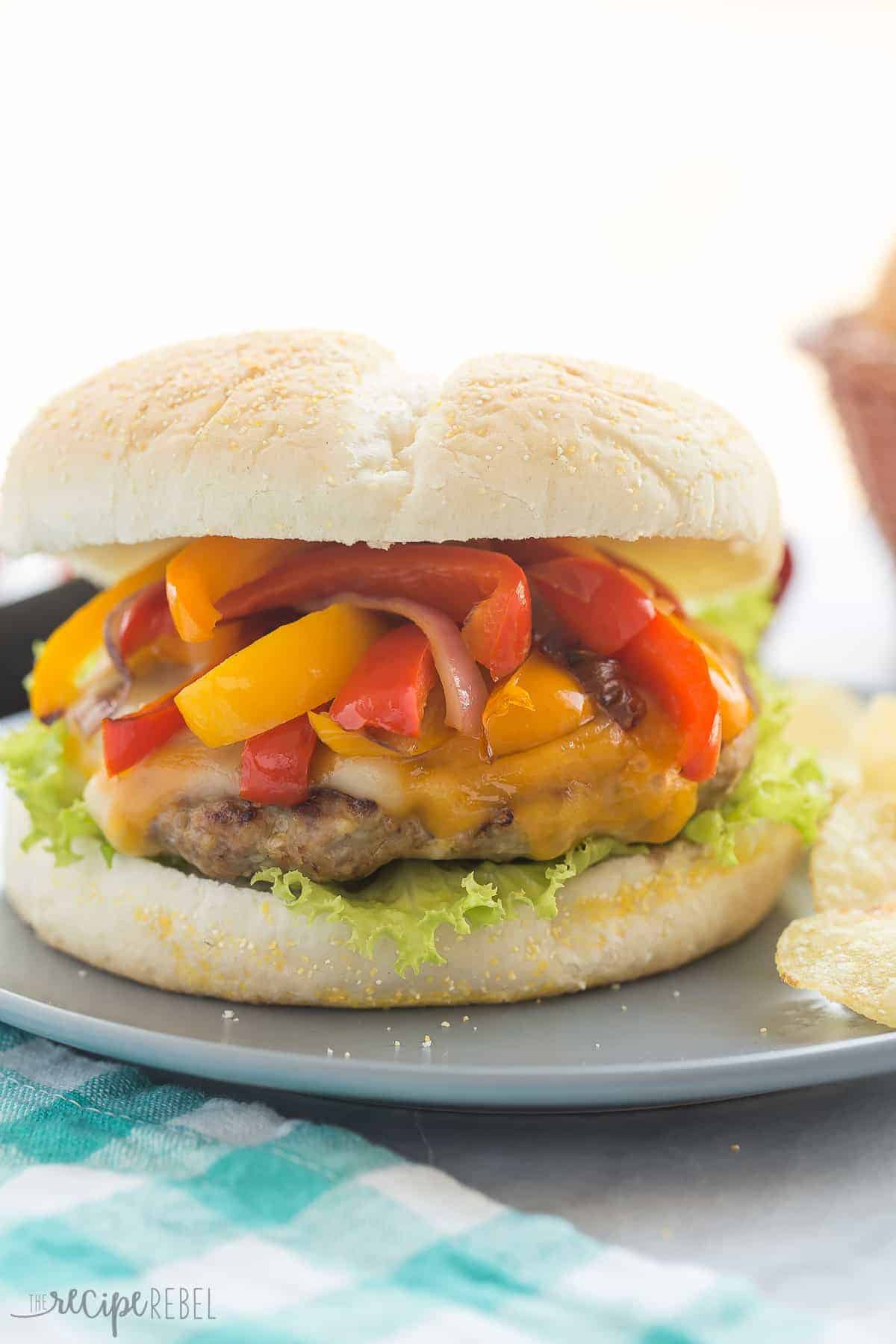 fajita turkey burgers on white bun with sauteed peppers onions and melted cheese