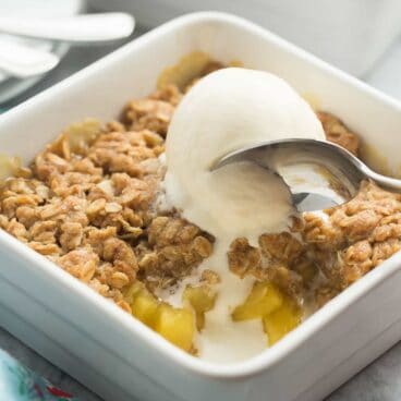 For pineapple lovers! This Pineapple Crisp is loaded with fresh pineapple chunks, topped with a brown sugar streusel, and baked until golden! SO good with vanilla ice cream! Easily gluten free dessert.