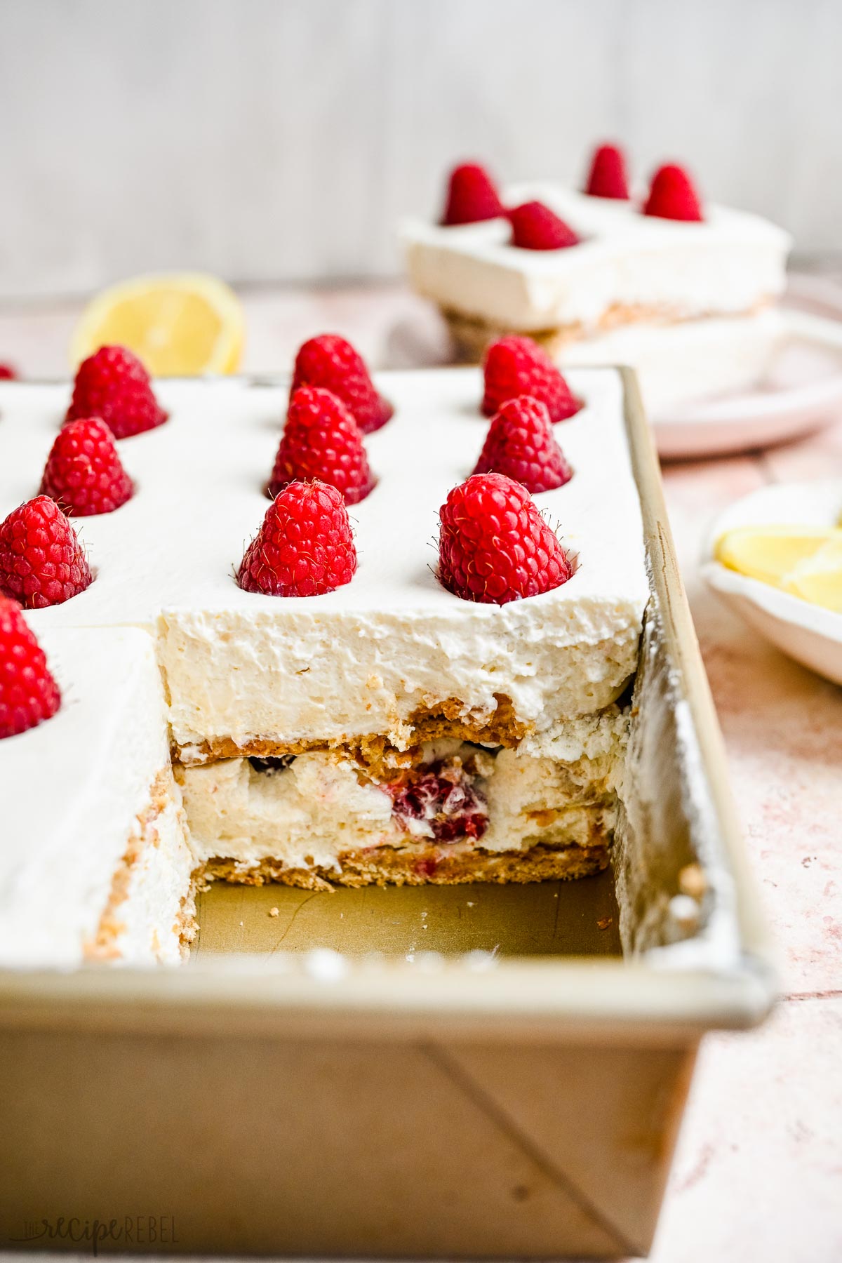 pan of lemon raspberry icebox cake with piece missing.