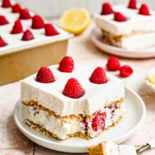 two pieces of lemon icebox cake on plates with pan in the background.