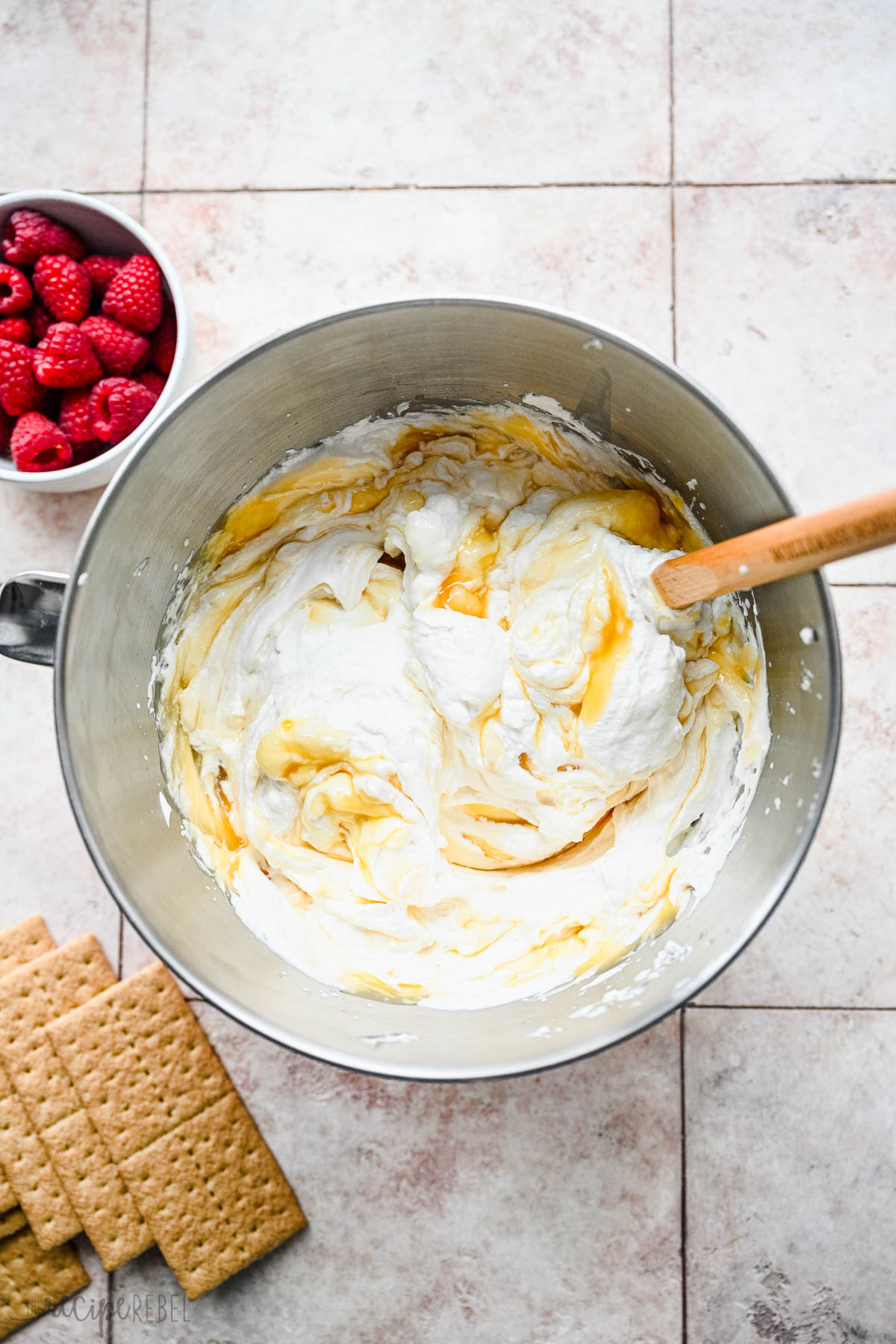 lemon curd being folded into whipped cream.