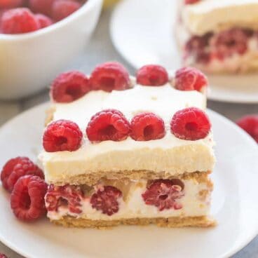 Graham crackers layered with whipped cream, lemon curd and a pile of fresh raspberries! This Lemon Raspberry Icebox Cake is an EASY no bake dessert for Spring!