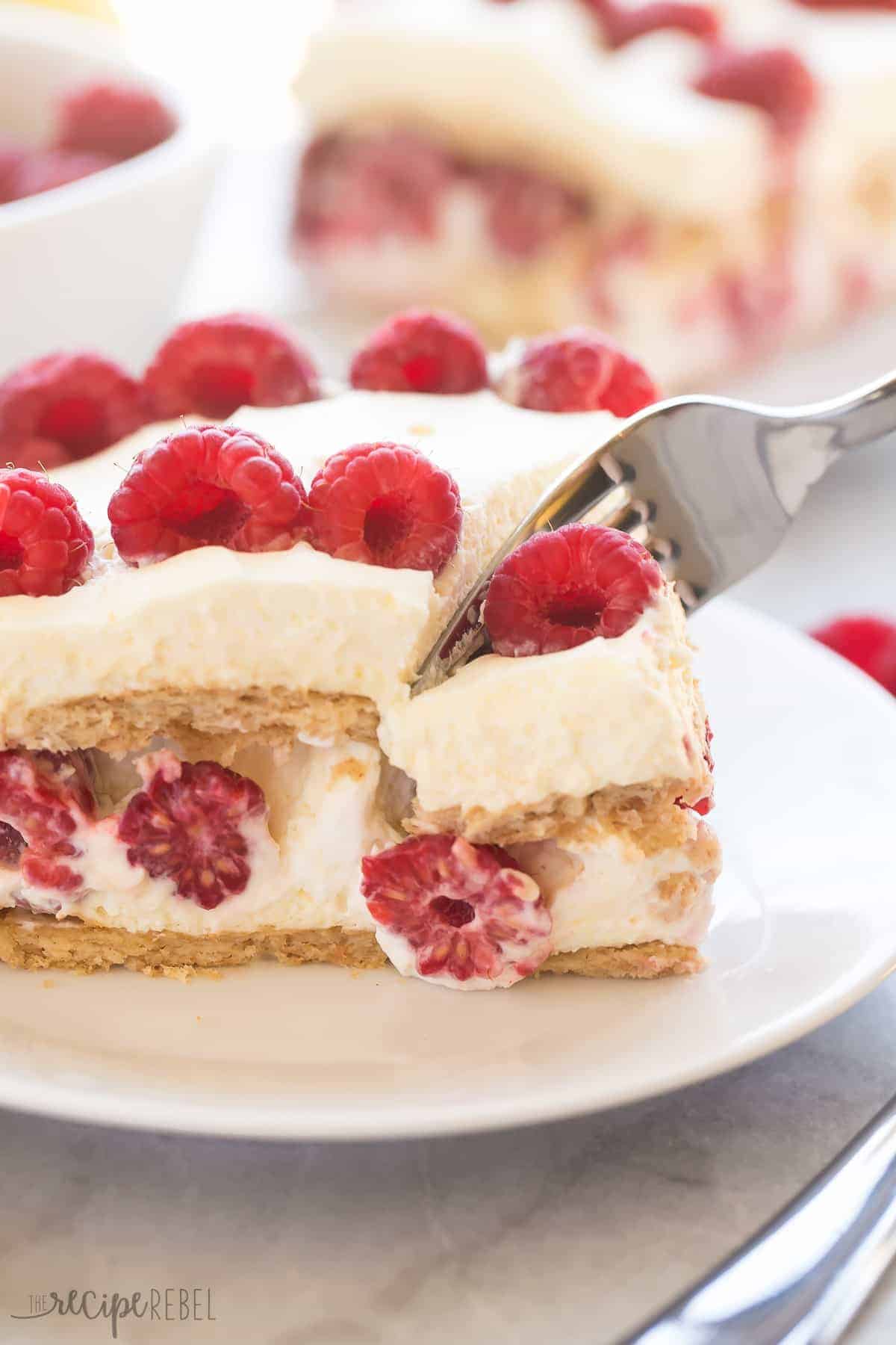 Graham crackers layered with whipped cream, lemon curd and a pile of fresh raspberries! This Lemon Raspberry Icebox Cake is an EASY no bake dessert for Spring!