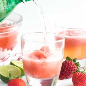 This Berry Lime Slush is a cold, frosty summer drink that will keep your thirst quenched! It's great for storing in the freezer and pulling out for surprise visitors, picnics and barbecues! https://www.thereciperebel.com/berry-lime-slush-recipe/