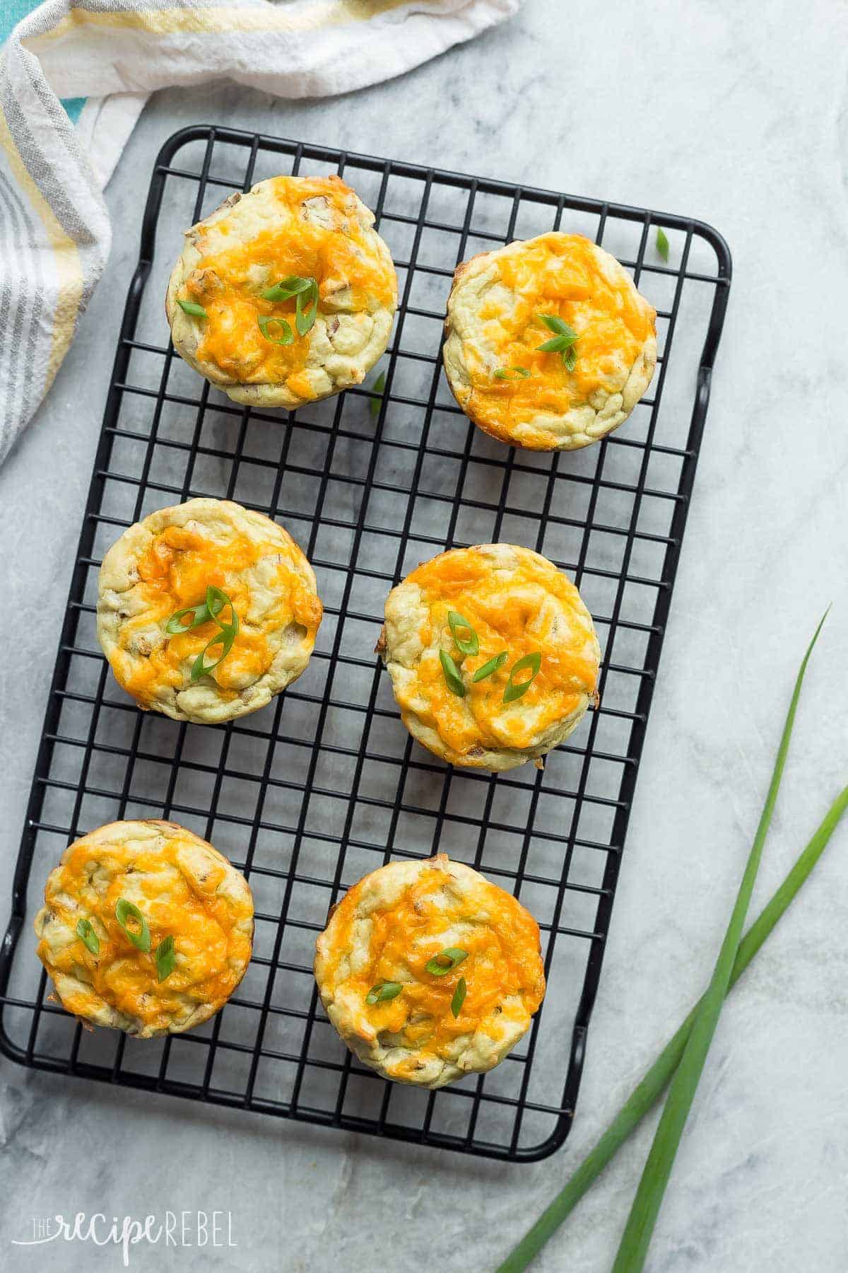 leftover mashed potato puffs with cheddar cheese and green onions overhead on black cooling rack