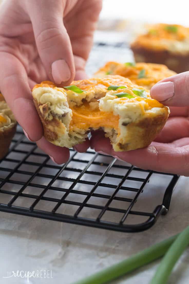cheese stuffed mashed potato puffs  in hands being pulled apart to reveal cheese