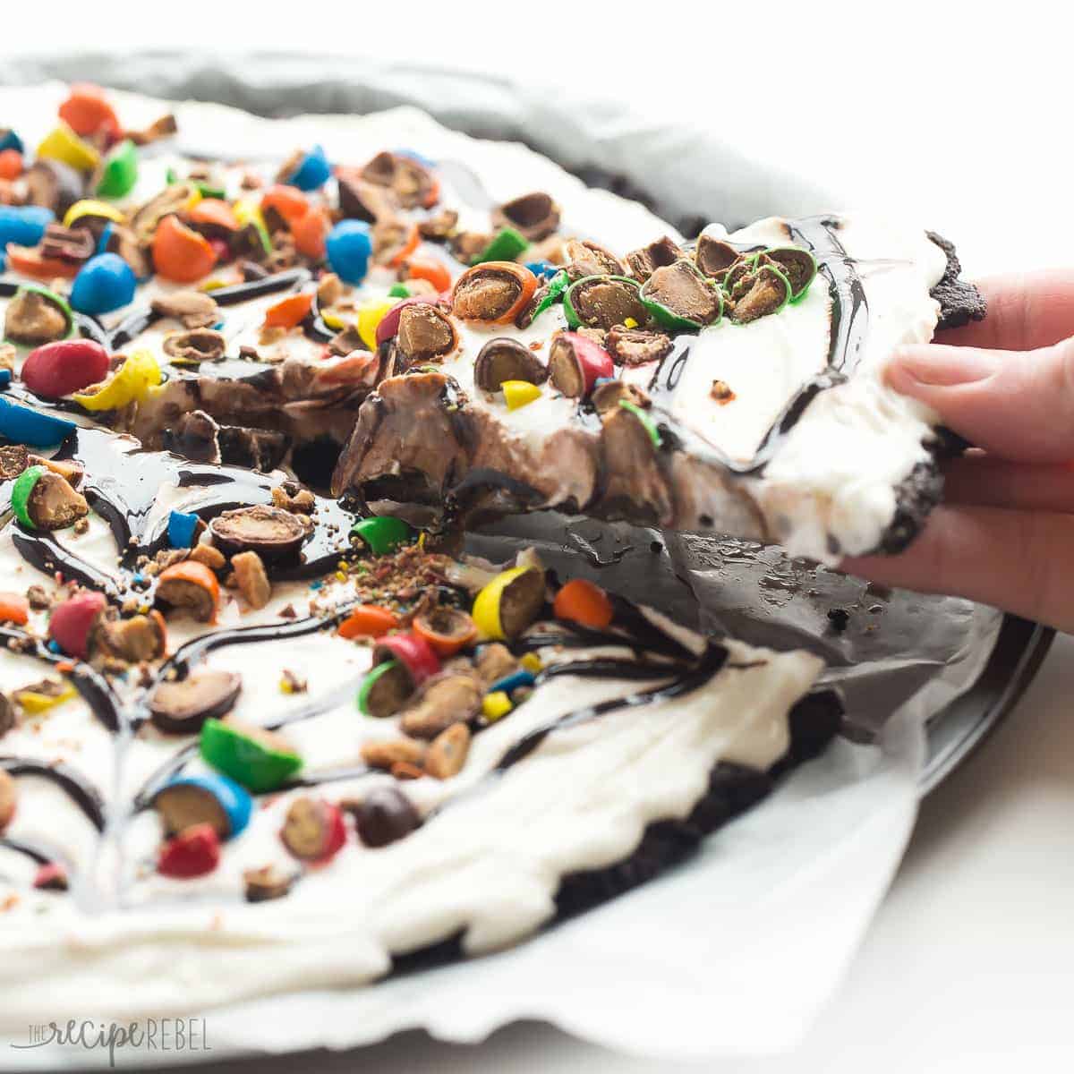 slice of frozen dessert pizza being pulled out by hand