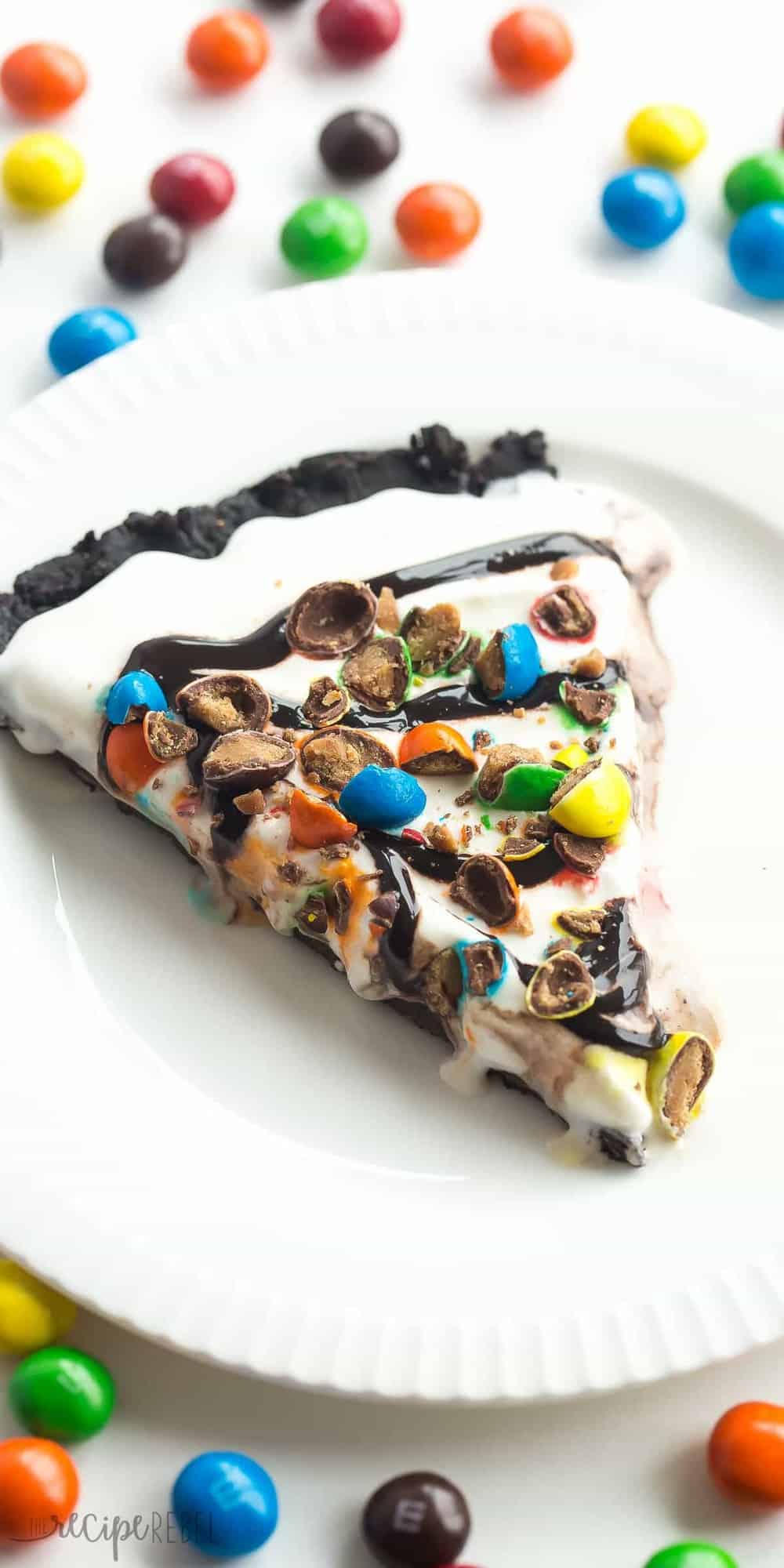 slice of frozen dessert pizza on white plate with chocolate sauce and M&Ms