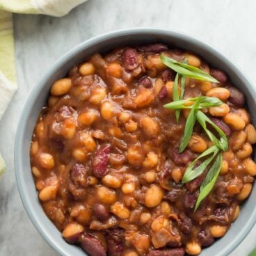 We LOVE these for summer barbecues! Healthier Slow Cooker Baked Beans that pack a big punch of flavor with maple syrup and balsamic vinegar -- great cold or warm! Gluten free. www.thereciperebel.com