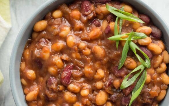 We LOVE these for summer barbecues! Healthier Slow Cooker Baked Beans that pack a big punch of flavor with maple syrup and balsamic vinegar -- great cold or warm! Gluten free. www.thereciperebel.com