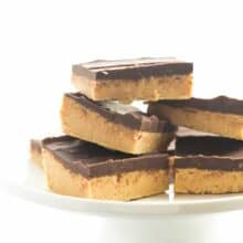 One ingredient makes these No Bake Chocolate Peanut Butter Bars BETTER than all the rest! They taste just like Reese's and are highly addictive! thereciperebel.com