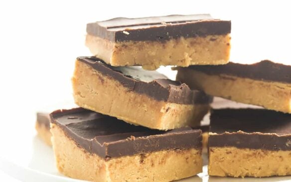 One ingredient makes these No Bake Chocolate Peanut Butter Bars BETTER than all the rest! They taste just like Reese's and are highly addictive! thereciperebel.com