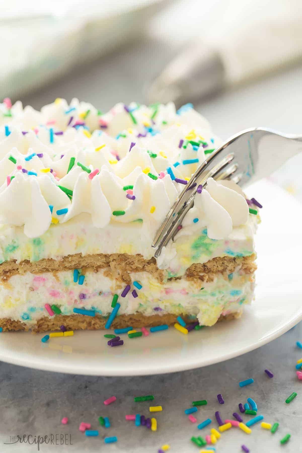 close up image of piece of funfetti icebox cake with fork taking a bite