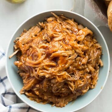 This easy Slow Cooker Pineapple Brown Sugar Pulled Pork recipe is smothered in homemade pineapple brown sugar barbecue sauce! Sweet, tangy and so tender! https://www.thereciperebel.com/slow-cooker-pineapple-brown-sugar-pulled-pork/