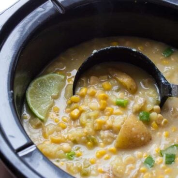 slow cooker potato corn chowder with jalapeno in crockpot with ladle