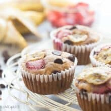 These Chocolate Chip Banana Muffins are the best -- so moist but made healthier with whole wheat flour, yogurt and loaded with fresh strawberries!