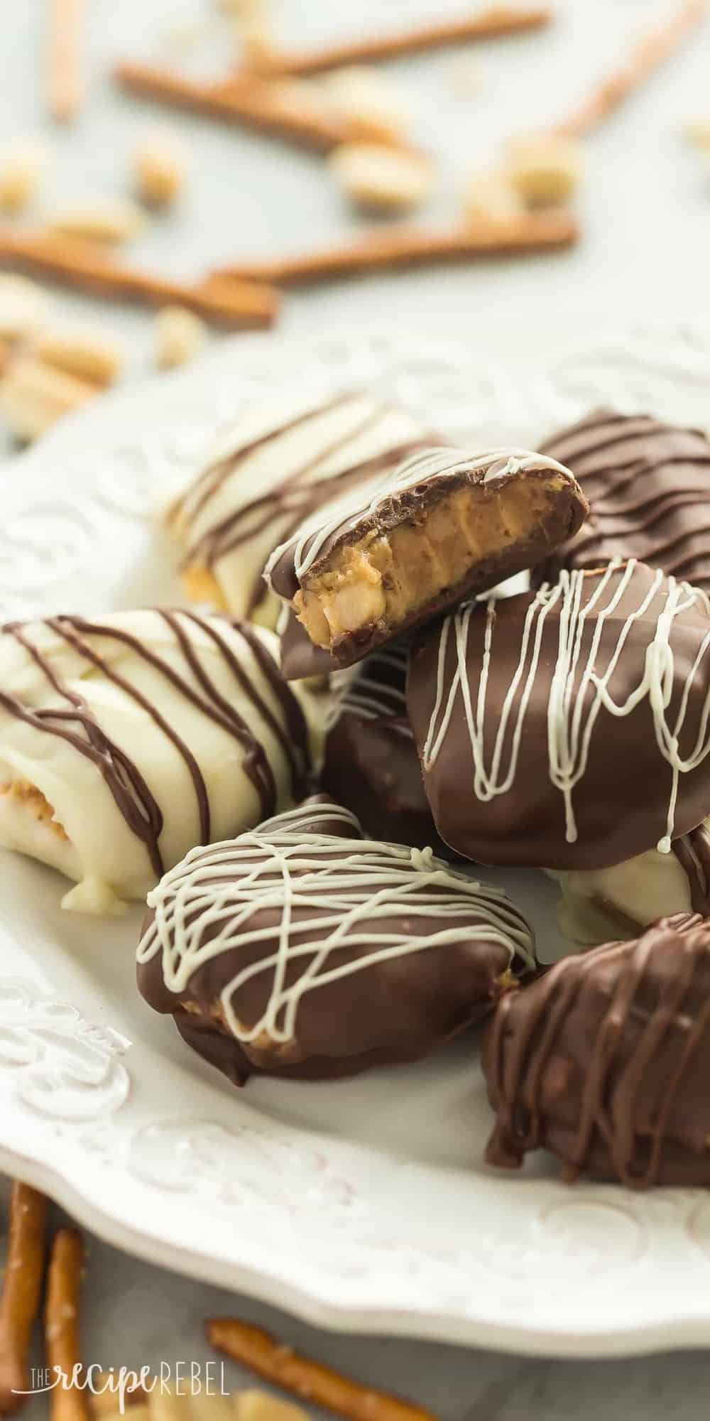 white chocolate and dark chocolate peanut butter pretzel candies stacked on plate 