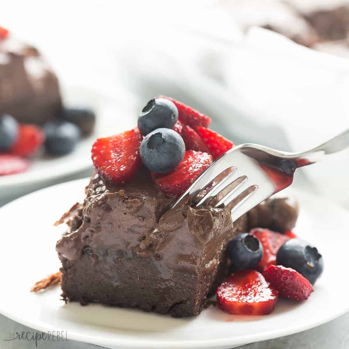 vegan chocolate truffle bars on white plate with fork taking a bite