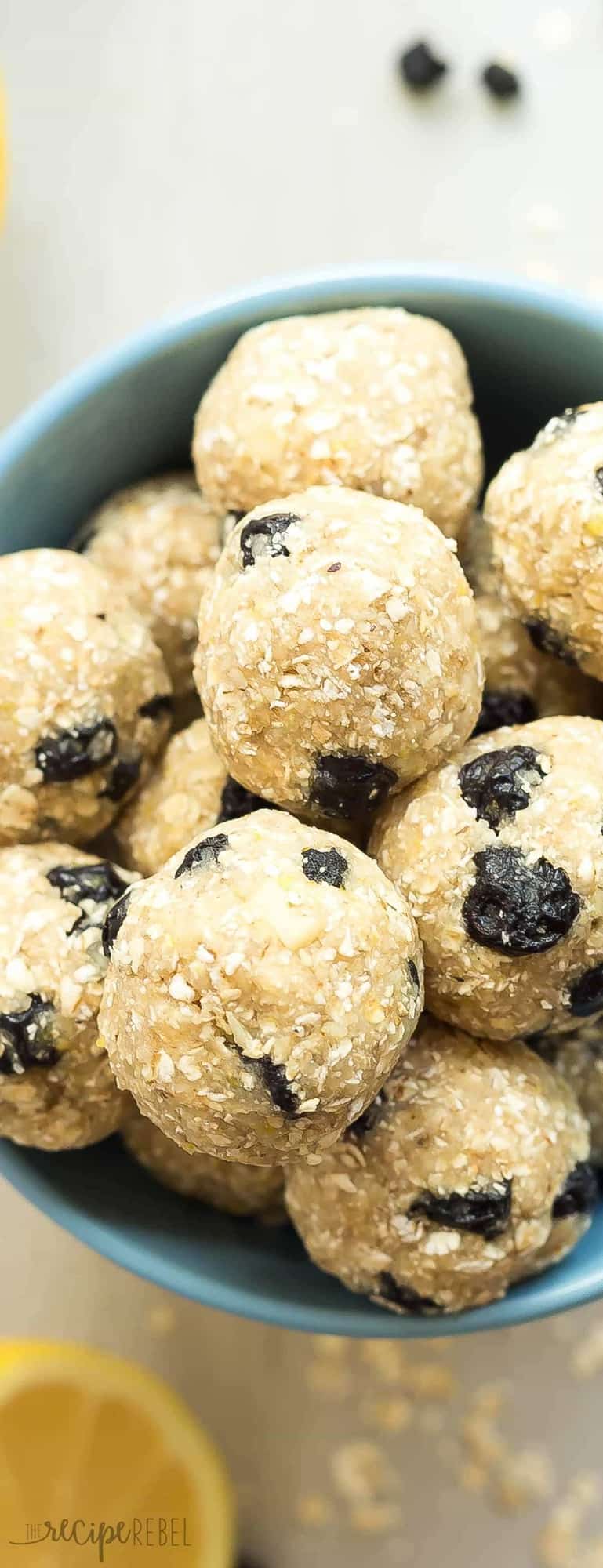 These Lemon Blueberry Energy Bites are an easy, no bake snack that's perfect for back to school or summer road trips! Just a few ingredients and they're gluten free with paleo and vegan options. Press them into a pan for granola bars! tall image of lemon blueberry energy bites close up in bowl