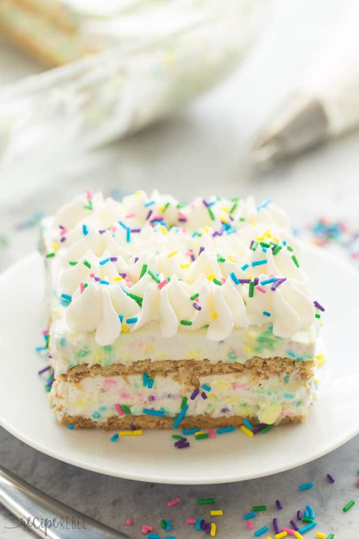 An easy, no bake icebox cake loaded with funfetti flavor! Only 10 MINUTES prep time and full of homemade cake batter flavor. no bake funfetti icebox cake piece on white plate with lots of sprinkles