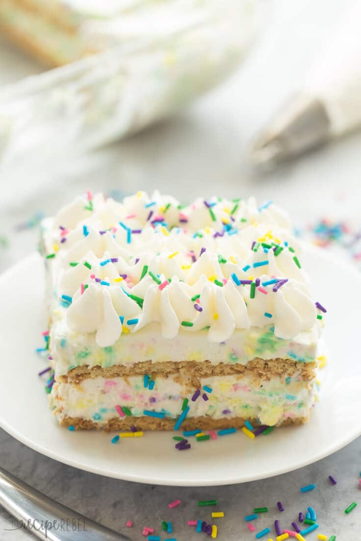 no bake funfetti icebox cake piece on white plate with lots of sprinkles