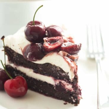 This Black Forest Cake is SO EASY and naturally gluten free -- and no gluten lover would ever know the difference! Chocolate Cake is layered with real whipped cream and homemade cherry sauce!
