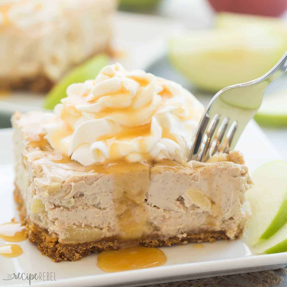 piece of caramel apple cheesecake bars on white plate with fork taking a bite