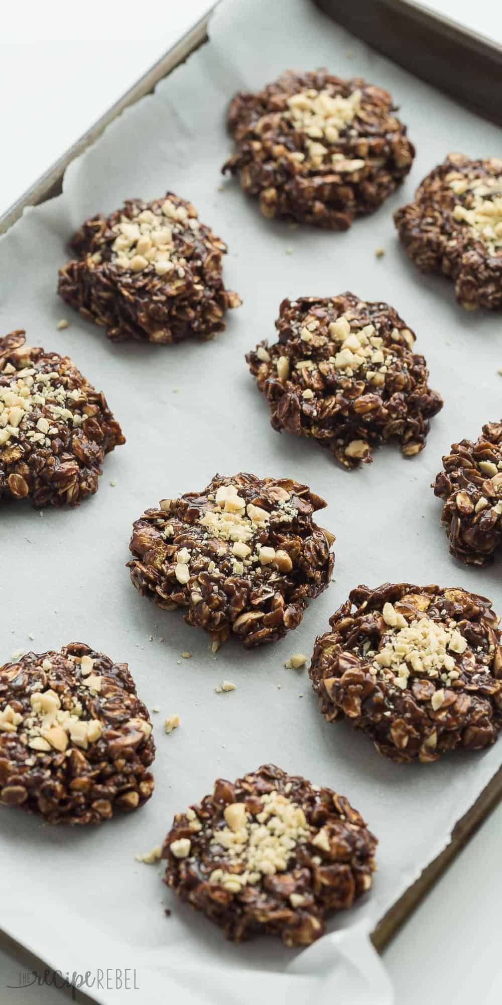 tall image of healthier chocolate peanut butter no bake cookies on sheet pan with parchment paper