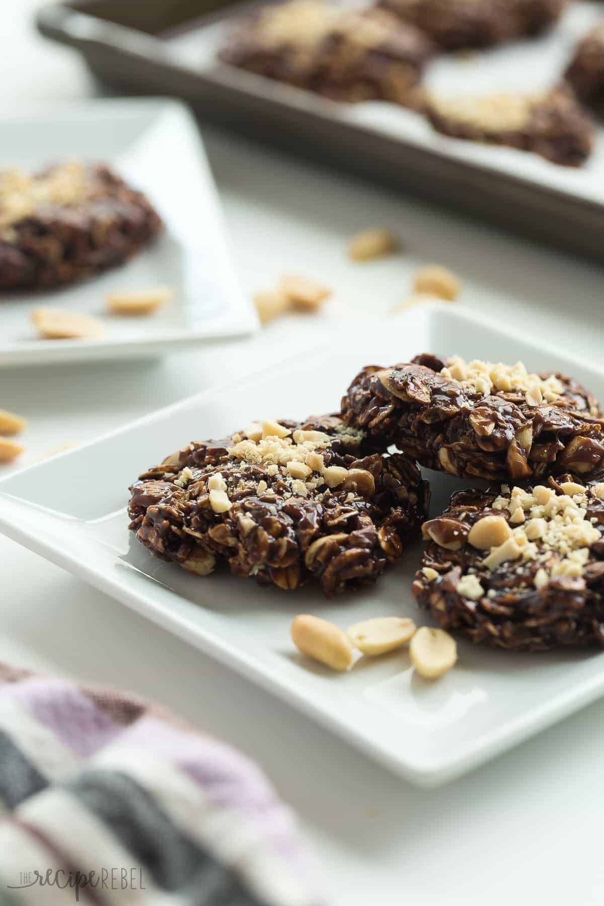 healthier chocolate peanut butter no bake cookies on white plate with chopped peanuts