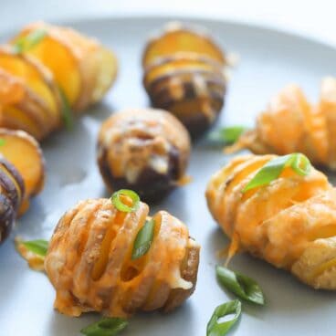 These Little Cheesy Hasselback Potatoes are a fun side dish or appetizer! They take less time to bake and are more "poppable" than large potatoes so they're perfect for kids!