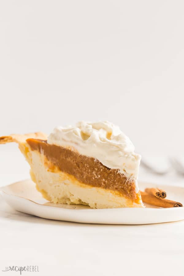 slice of cream cheese pumpkin pie up close on white plate with white background