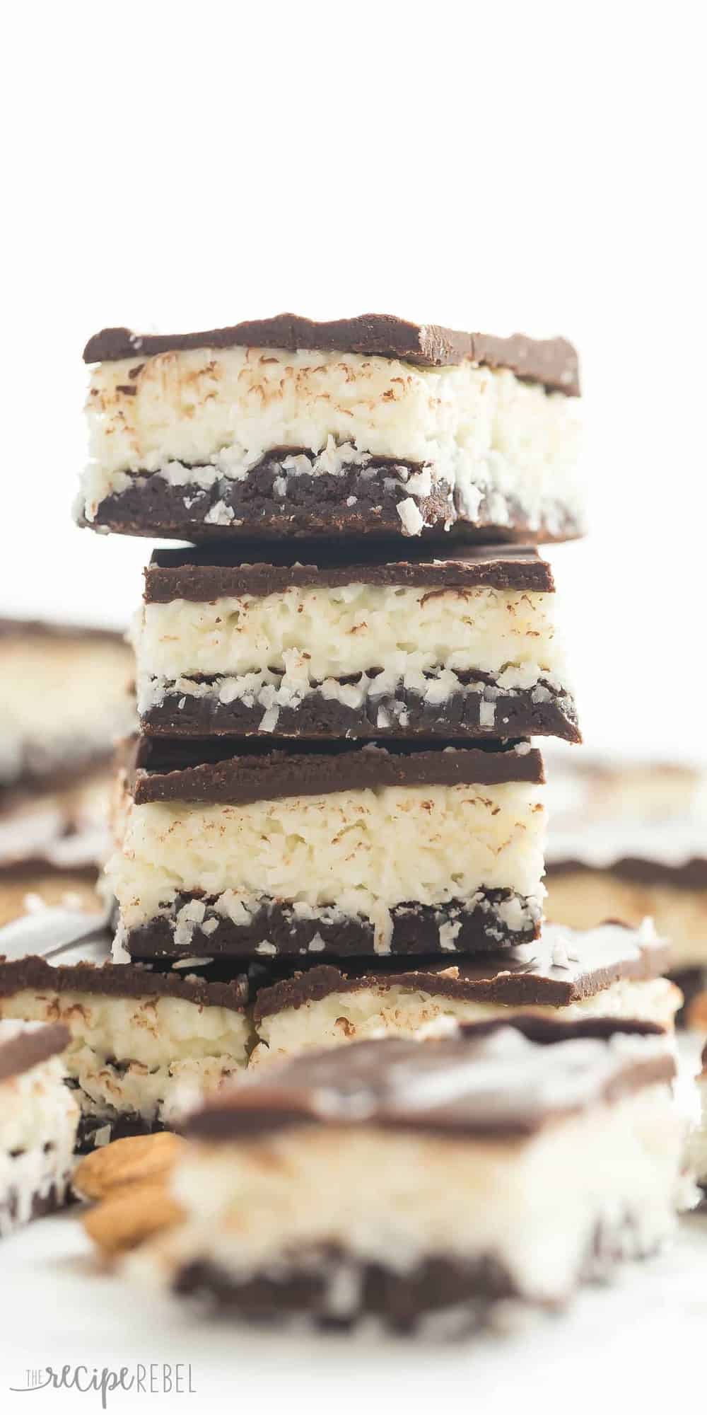 stack of 4 almond joy brownies with coconut filling and chocolate ganache