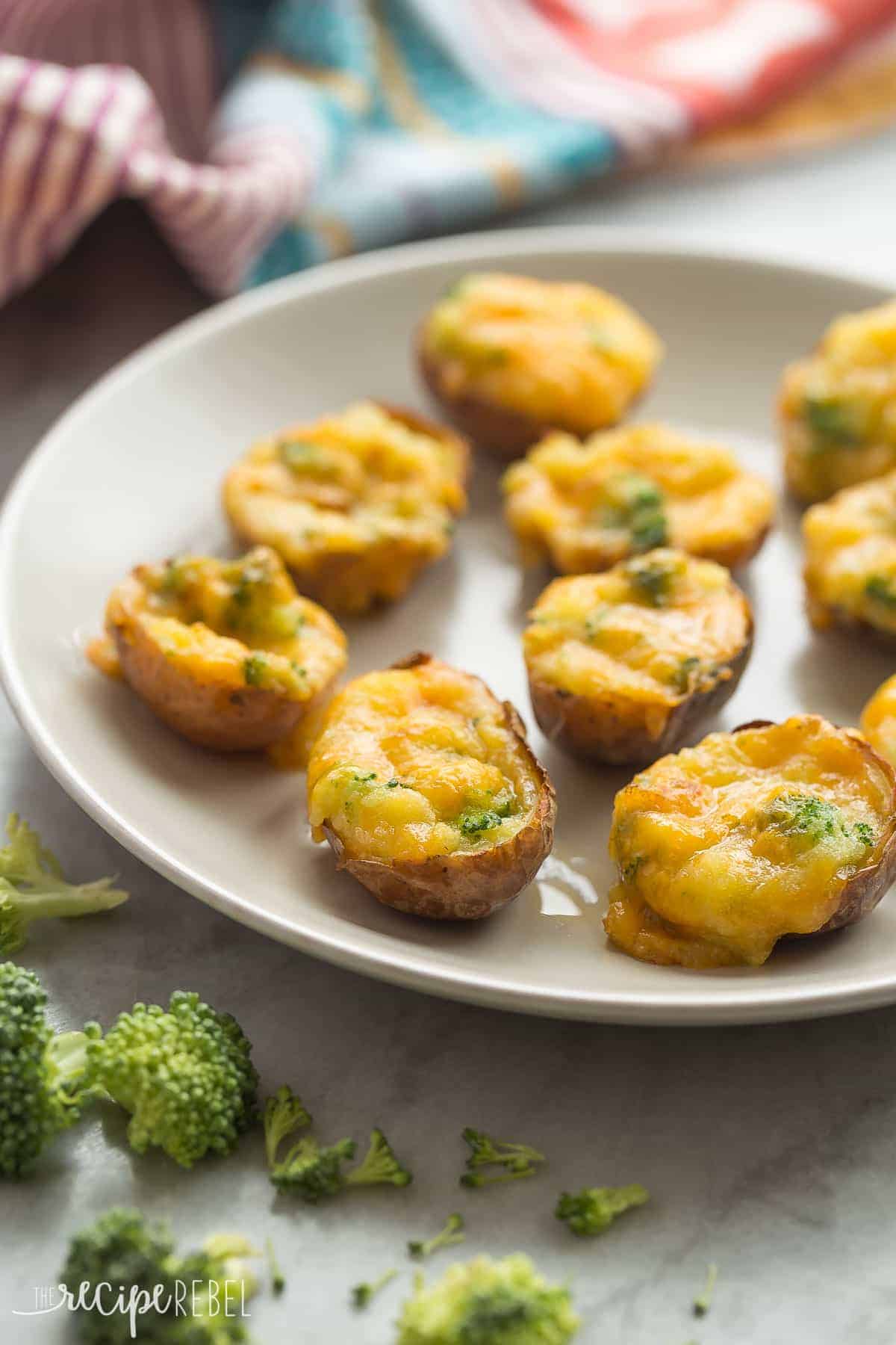broccoli cheddar twice baked potatoes on grey plate with colorful towel in the background