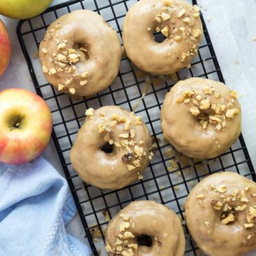 These Apple Cinnamon Baked Donuts are packed with apples (healthy, right?!) and cinnamon -- the perfect fall treat! Smothered in a brown sugar glaze that makes these a decadent dessert or special breakfast :)