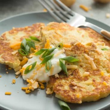These Cheesy Mashed Potato Pancakes are one of the best ways to use up leftover mashed potatoes! Just 5 ingredients and a few minutes prep.