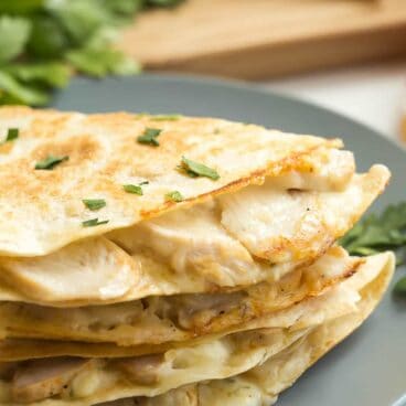 These Chicken Alfredo Quesadillas are an easy lunch, dinner or snack! They're filled with leftover chicken, Alfredo sauce and cheese -- easy comfort food! A 10 minute meal.