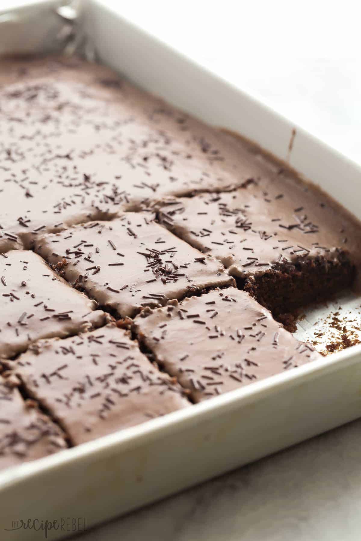large sheet pan with texas brownies cut into squares and one square missing