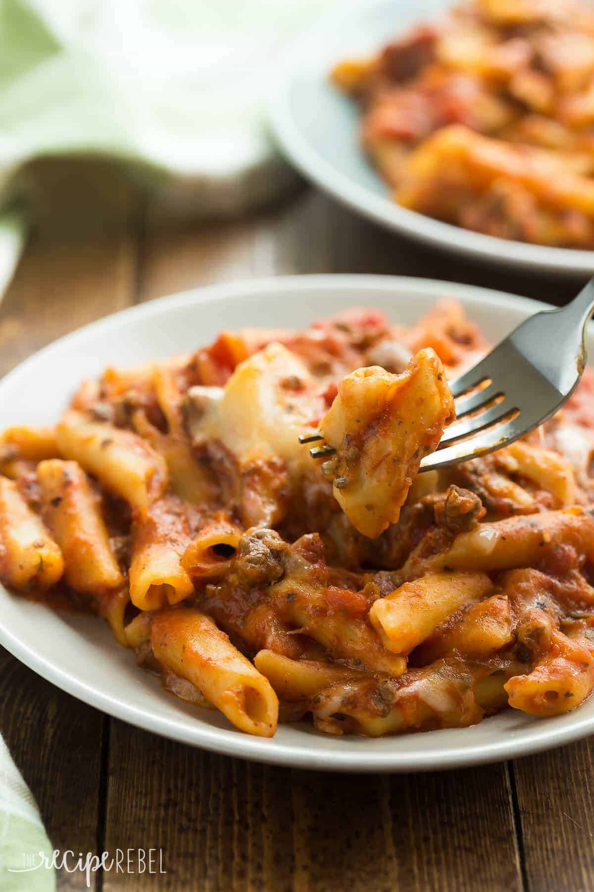 slow cooker baked ziti on grey plate close up on wooden background