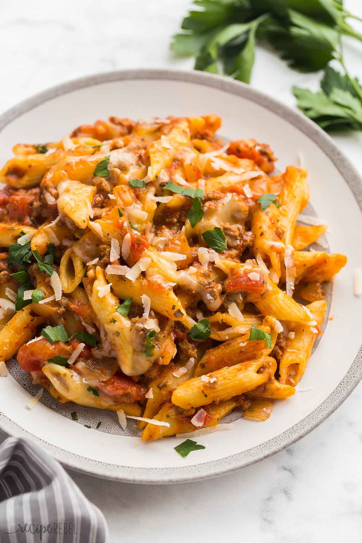 close up image of crockpot baked ziti on plate.