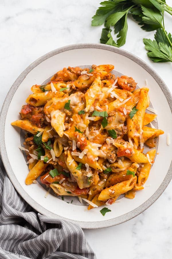 slow cooker baked ziti on plate overhead on white marble background