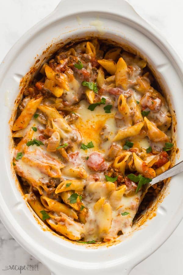slow cooker baked ziti in crock pot with spoon stuck into pasta