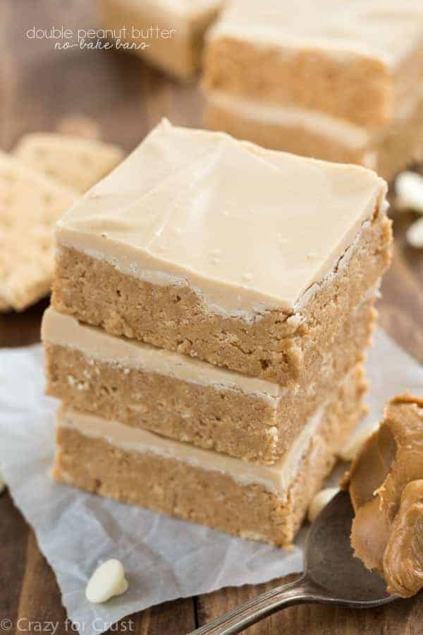 no bake double peanut butter bars stack of 3 with graham crackers in the background