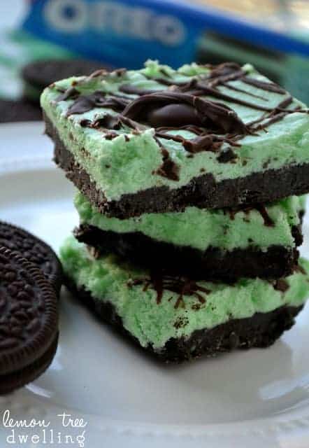 no bake mint oreo meltaways stack of 3 on white plate with oreo package in the background