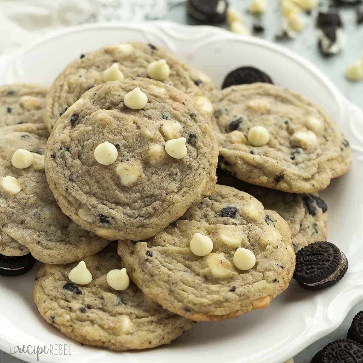 white plate of cookies and cream cookies with mini oreos and white chocolate chips