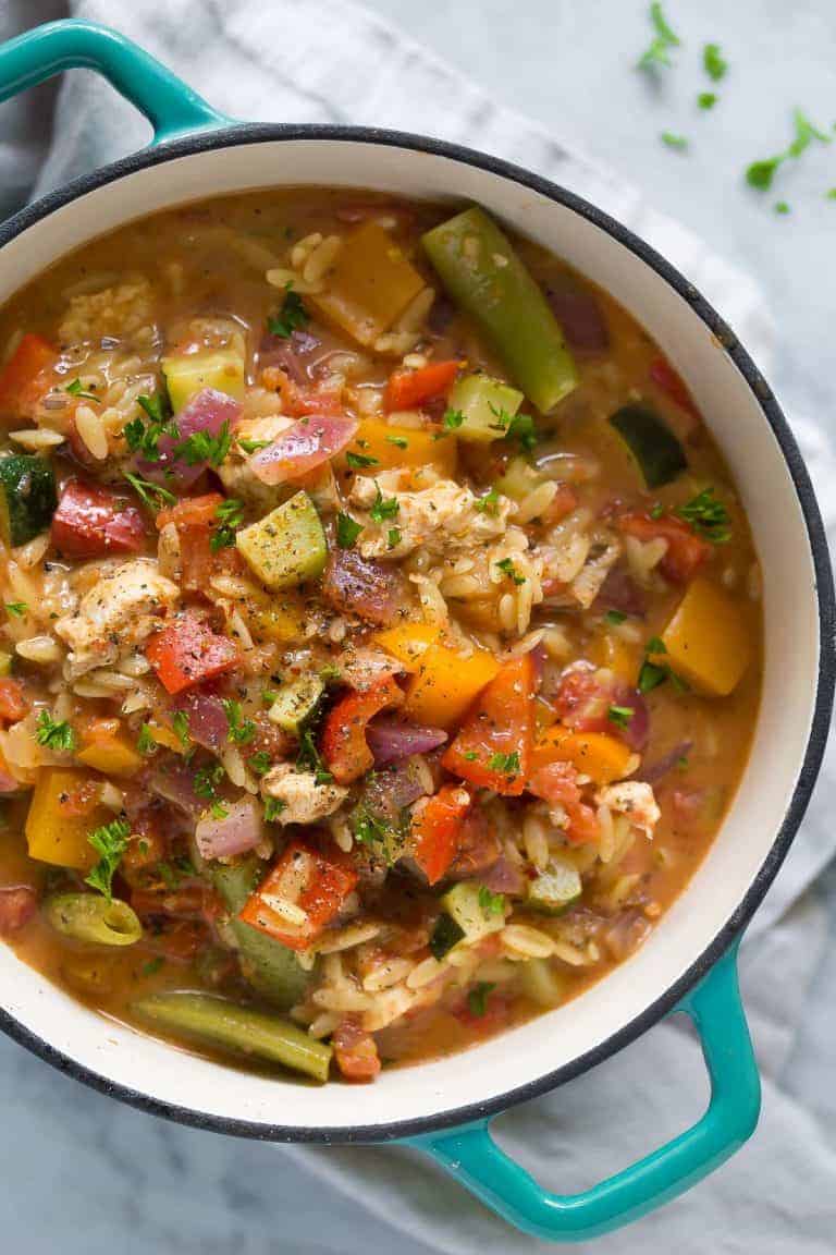 healthy cajun chicken orzo overhead in dutch oven with blue handles