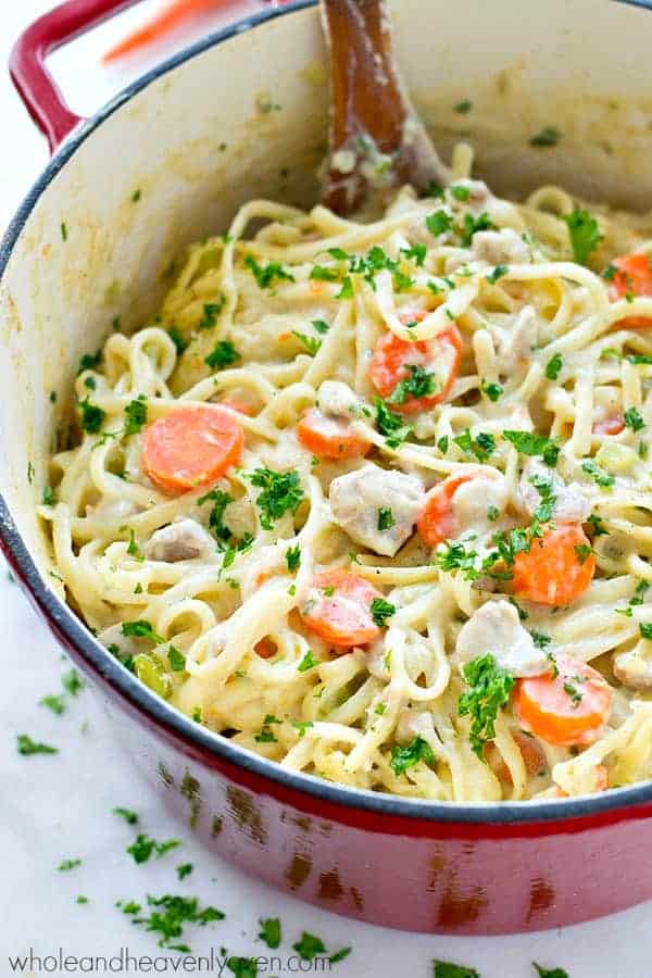 chicken pot pie fettuccine in large dutch oven with carrots and fresh parsley