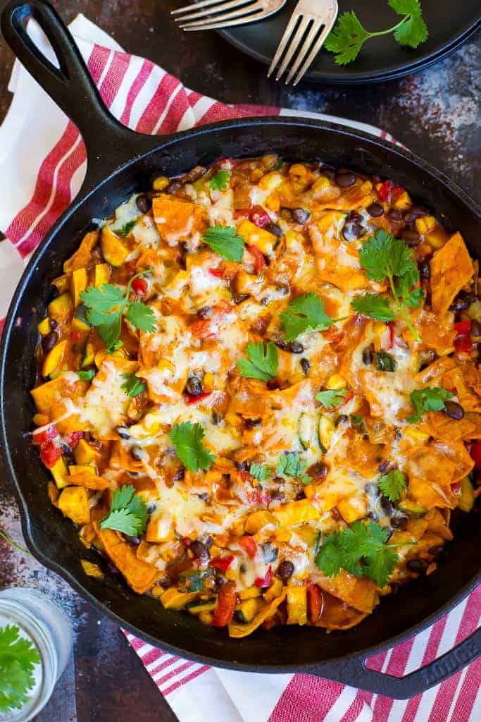 one pot stovetop enchiladas in black cast iron skillet with fresh cilantro