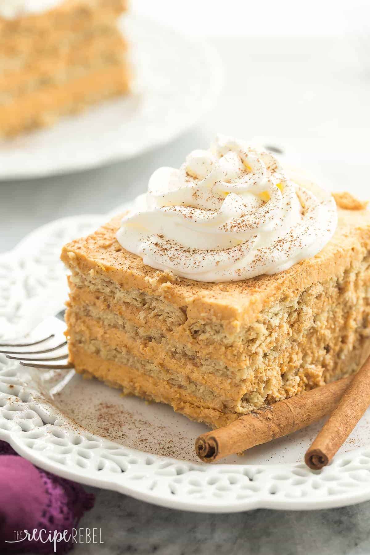 one piece of pumpkin pie icebox cake with whipped cream and cinnamon on white plate