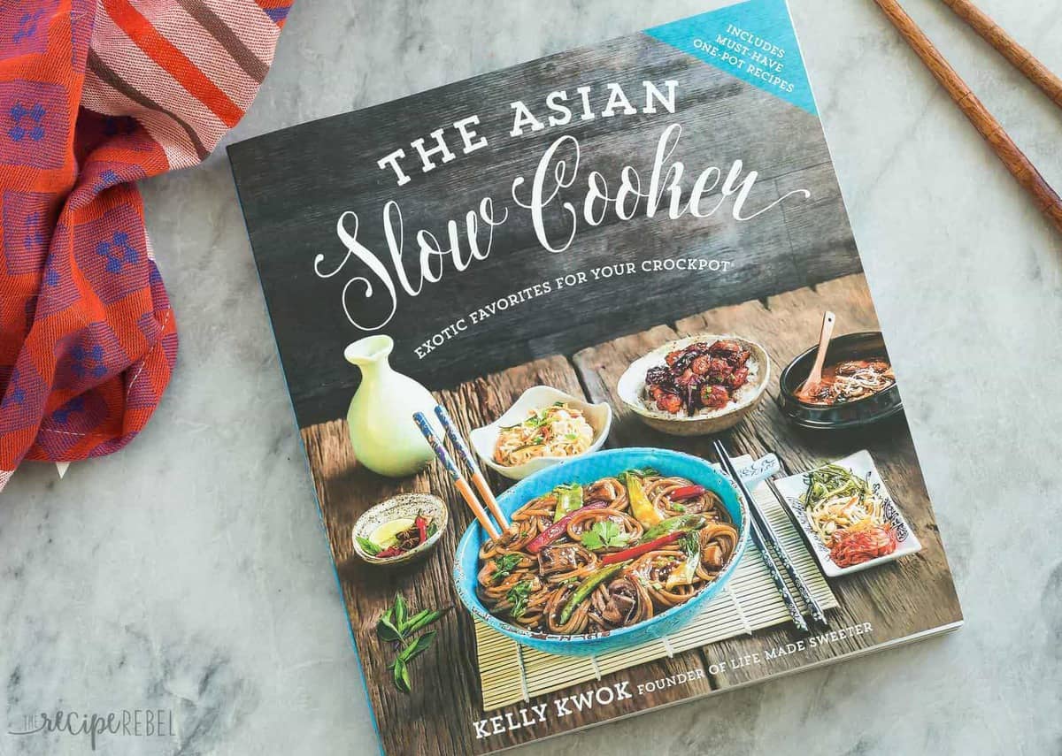 the asian slow cooker cookbook on grey marble background